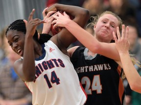 Holy Names Knights' Mildred Okoko battles Orillia Nighthawks' Charlotte Van Amelsvoort for the ball during their OFSAA AAA basketball game on Friday, Nov. 27, 2015, in Windsor, Ont. Holy Names lost the game 39-30 and was eliminated from the tournament.