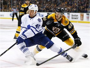 Toronto Maple Leafs' Michael Grabner tries to turn away from Boston Bruins defenceman Colin Miller (48) during the third period of the Boston Bruins 2-0 win in an NHL hockey game in Boston, Saturday, Nov. 21, 2015.