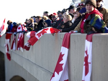 Hundreds of people gathered on the Colonel Talbot overpass to pay their respects as a hearse carrying the body of John Gallagher traveled  along HWY 401 through London enroute to a funeral home  in Bleheim, Ont. on Friday November 20, 2015. Gallagher was killed on November 4 while fighting alongside Kurdish forces against ISIS in Syria.