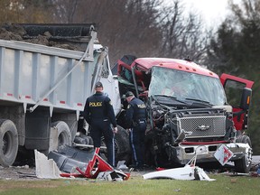 O.P.P. officers investigate a serious collision at the intersection of Naylor Side Road and South Middle Road in Lakeshore, Ont. on Thursday, Nov. 26, 2015.