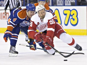 Detroit Red Wings' Niklas Kronwall (55) is tripped by Edmonton Oilers' Taylor Hall (4) during a game in October in Edmonton. The Oilers (7-14-1) ended an eight-game losing streak in the series with a 3-1 victory Oct. 21, 2015.