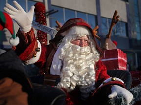 Santa waves to the crowd as he makes his way down Ouellette Avenue during the Holiday Parade, Saturday, Nov. 30, 2013.