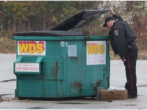 A Windsor Police officer investigates the scene of an armed robbery at the Totten Pharmacy on Tuesday, November 10, 2015 in Windsor, ON.