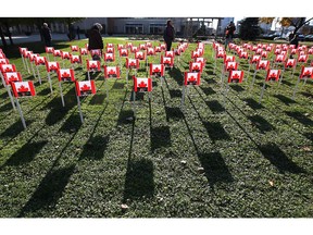 In this file photo, flags bearing the names of fallen soldiers are shown at the downtown Remembrance Day ceremony on Tuesday, Nov. 11, 2014, in Windsor, ON. (DAN JANISSE/The Windsor Star)