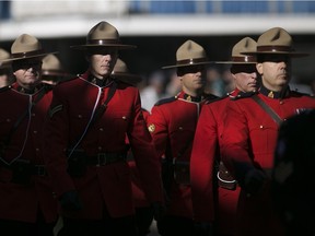 Members of the Royal Canadian Mounted Police march in the Remembrance Day parade before the start of a ceremony hosted by the Royal Canadian Legion and the HMCS Hunter at the Cenotaph in downtown Windsor, Sunday, Nov. 8, 2015.