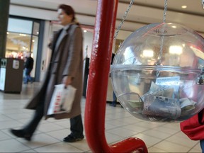 Shoppers walk past one of the Salvation Army kettles at the Devonshire Mall in Windsor in this file photo.