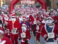 Hundreds of runners dressed up in Santa suits take part in the Super Santa 5k Run or Walk in Amherstburg on Nov. 14, 2015.