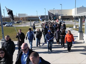 Protesters walk outside of the Southwest Detention Centre on Friday, Nov. 20, 2015.