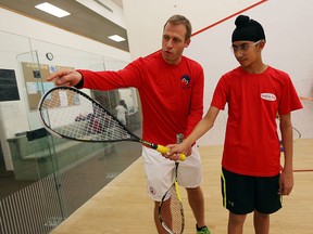 Windsor Squash and Fitness pro Graeme Williams gives a squash lesson to Jagroop Bhangoo and other students at the club recently.