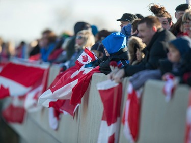 Hundreds of supporters line an overpass near London, Ontario, Friday, November 20, 2015 as they await the procession for former Canadian soldier John Gallagher, who was killed while fighting against ISIS as a volunteer with the Kurdish YPG guerillas.