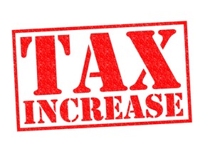 Tax increase red rubber stamp over a white background. Image by fotolia.com.