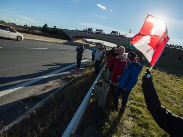 The procession for former Canadian soldier John Gallagher, who was killed while fighting against ISIS in Syria, passes by London, Ontario, Friday, November 20, 2015 where hundreds lined overpasses to pay their respects.