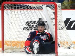 Windsor Spitfires' Christian Fischer ends up in the net during a rush up ice against the Guelph Storm on Sunday, Nov. 8, 2015, in Guelph. Windsor won 4-0.