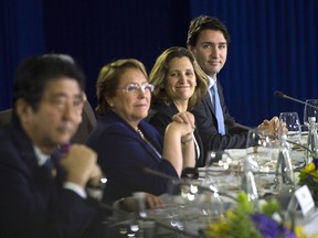 Prime Minister Justin Trudeau, right, sits beside Minister of International Trade Chrystia Freeland as they take part in a Trans-Pacific Partnership meeting on the side-lines of the APEC Summit in Manila, Philippines on Wednesday, November 18, 2015.