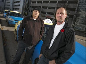 Moe Abouzeeni, left, chairman of the Vet's Cab Unifor Local 195, and John Toth, vice president of Unifor Local 195, are pictured on Chatham St. E at a taxi stand behind Caesars Windsor, Sunday, Nov. 1, 2015.