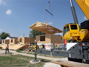 Construction crews with Habitat for Humanity raise the roof onto one of four new homes being built in Windsor on Saturday, May 2, 2007.