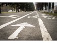 White pedestrian cycle and footpath in white paint with an arrow sign. Photo by fotolia.com.
