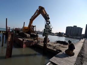 Construction crews work on the dock area of the Windsor Yacht Club in Windsor on Wednesday, November 11, 2015.