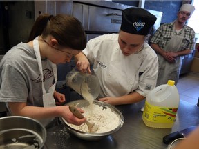 Julia Lane, left, and instructor Cassandra McNiece make pretzels using their own recipe while Paul Morgan looks on at the Earnest Bagel in Windsor on Monday, Nov. 16, 2015. Students at Westview Freedom Academy created and tested the recipe.