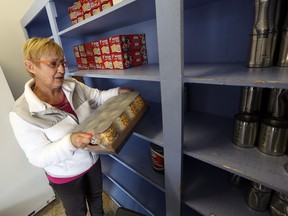 Shirley Beaton surveys the near empty shelves at the Windsor Homes Coalition food bank in Windsor on Thursday, Nov. 19, 2015. The food bank had to close its doors for the first time in their 45-year history.