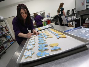 Saskia Scott shows how to frost some Hanukkah themed cookies at the Sweet Revenge Bake Shop in Windsor recently.
