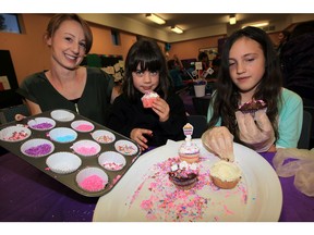 Big Brothers, Big Sisters Windsor Essex Foundation group monitoring co-ordinator Brittany Davidson, left, helps Sierra and Macenzie, right, during an after-school program at Big Brothers, Big Sisters Tuesday November 10, 2015. The program is possible because of a generous, $5,000 donation from RBC Royal Bank who were on hand Tuesday for a cheque presentation. Two dozen children, who are waiting their turn for a Big Brother or Big Sister, joined in the fun with decorating cupcakes, pizza and gifts from RBC.