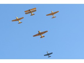 Vintage planes pass in the sky during the 2015  Remembrance Day Ceremony in downtown Windsor, Ontario on November 11, 2015.  (JASON KRYK/WINDSOR STAR)