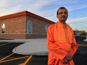 Priest Paresh Pandya stands recently in front of the new Hindu Temple (Mandir), on Enterprise Way, which is nearly triple the size of the old temple. "It's a big landmark for not just our community, but all of Windsor too," said Harshad Joshi, one of the temple's board members.