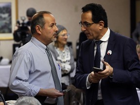 Speakers Ridwan Tamr, left, and Dr. Ahmad Chaker, both members of Syrian Canadian Council, Windsor Chapter, discuss details of a co-ordination meeting for Syrian refugees at Days Inn on Monday, Nov. 30, 2015.