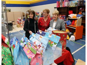 From, left, Jean Brennan, Mary Dozzi, and Lowanna Kloss room the Divine Mercy Food Bank are seen with hundreds of Christmas boxes and school kids, teens and adults They boxes will be distributed early because they are moving to a new location. (JASON KRYK/Windsor Star)