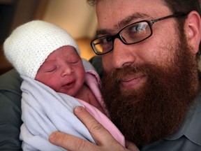 Rabbi Sholom Galperin proudly holds his newborn son, who was born seven minutes into the New Year at Windsor Regional Hospital's Met Campus,  Jan. 1, 2015.