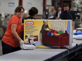 Canada Post's Donna Risdale, left, at Windsor parcel hub on Walker Road where workers sort packages Wednesday Dec. 09, 2015.