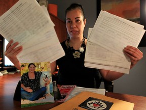 Darlene Dunn Mahler, office of MP Brian Masse, holds petition Thursday, Dec. 10, 2015.  A campaign photograph of Cassandra Kaake, who was 7 months pregnant when she was killed, is displayed at bottom, left.