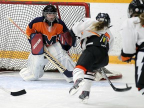 L'Essor's Maggi Dewolf-Russ, right, fires a shot at Massey's Tessa Rupert at South Windsor Arena in Windsor on Wednesday, December 9, 2015.             (TYLER BROWNBRIDGE/Windsor Star)