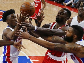 Detroit Pistons forward Stanley Johnson, from left, Memphis Grizzlies forward Jeff Green (32) Detroit Pistons forward Marcus Morris (13) battle for a rebound in the first half of an NBA basketball game Wednesday, Dec. 9, 2015 in Auburn Hills, Mich. (AP Photo/Paul Sancya)
