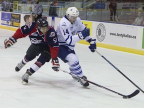Windsor Spitfires' Jalen Chatfield (51) steals the puck from Mississauga Steelheads' Nathan Bastian (14) in the first period of the Ontario Hockey League game held at the Hershey Centre on Friday night. (Mississauga News)
