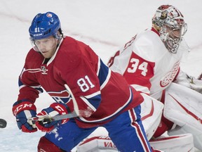 Montreal Canadiens' Lars Eller, left, chases down the puck as Detroit Red Wings' goaltender Petr Mrazek defends his end during third period NHL hockey action in Montreal, Saturday, Oct. 17, 2015. THE CANADIAN PRESS/Graham Hughes