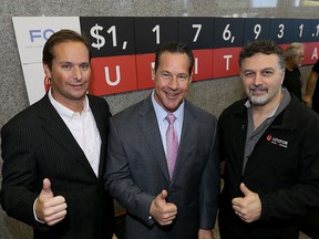 FCA Windsor Assembly Plant Manager Mike Brieda, left, FCA Canada President and CEO Reid Bigland and Dino Chiodo, president Unifor Local 444, all cheer the great contribution of FCA Canada employees and retires for pledge of over $1.1 million toward United Way/Centraide Windsor-Essex County.