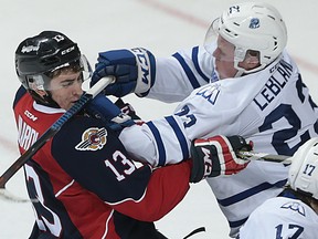 Gabriel Vilardi (L) of Windsor takes a stick to the face from Stefan LeBlanc of Mississauga during their game at the WFCU Centre on Thursday, Dec. 10, 2015 in Windsor, Ont. (DAN JANISSE/The Windsor Star)ar)
