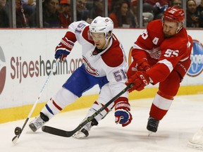 Detroit Red Wings defenseman Niklas Kronwall (55) defends Montreal Canadiens center David Desharnais (51) in the first period of an NHL hockey game Thursday, Dec. 10, 2015 in Detroit. (AP Photo/Paul Sancya)