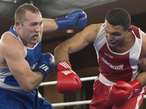 Windsor's Samir El Mais, right, lands a right to the head of Paul Rasmussen on his way to a unanimous decision in their 91kg bout at the Canadian Olympic Boxing trials, in Montreal, on Thursday, Dec. 10, 2015. THE CANADIAN PRESS/Ryan Remiorz