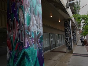 Murals showing past business of Farmer's Market, left, and Custom Tattoo once located at street-level retail spaces within Pelissier Street Parking Garage in this 2015 file photo.