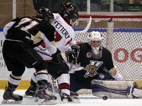 The LaSalle Vipers Devon Paliani looks to clear a loose puck as goaltender Cameron Zanussi makes a save on the Lampton Shores Predators Austin Fetterly at the Vollmer Centre in LaSalle on Wednesday, January 8, 2013.                        (TYLER BROWNBRIDGE/The Windsor Star)