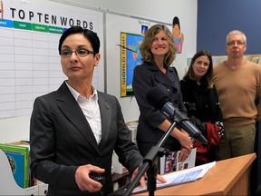 Ina Berard, special assignment teacher with Greater Essex County School Board, speaks at Newcomer Reception Centre during an event to outline their role. past and present, of educational support for new Canadian families arriving. Dr. Sharon Pyke, behind, and other officials participated in the session Dec. 17, 2015.