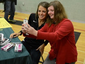 Former Lancer Melissa Bishop, left, takes a break from signing hundreds of autographs to pose for a selfie with Grade 9 Opeongo student Autumn Dombroskie after a Melissa Bishop Day ceremony at the school near her home town of Eganville Wednesday. Ryan Paulsen/Pembroke Daily Observer/Postmedia Network