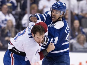Toronto Maple Leafs defenceman Mark Fraser, right, and Montreal Canadiens forward Zack Kassian fight during first period pre-season exhibition NHL hockey action in Toronto on Saturday, September 26, 2015. THE CANADIAN PRESS/Darren Calabrese