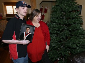 Jeff Harris and Lori Maukonen, parents of injured roofer Michael Maukonen, 19, are praying for Michael's recovery from two brain surgeries after a fall from a roof.  Harris and Maukonen and their family, had to stop their Christmas planning to be with their son.  They were leaving to visit Michael in ICU at Windsor Regional Hospital Ouellette Campus, Friday Dec. 18, 2015.