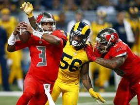 Tampa Bay Buccaneers quarterback Jameis Winston (3) scrambles away from St. Louis Rams outside linebacker Akeem Ayers (56) as Ayers is blocked by Buccaneers fullback Jorvorskie Lane during the third quarter of an NFL football game Thursday, Dec. 17, 2015, in St. Louis. (AP Photo/Billy Hurst)