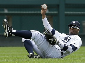 Detroit Tigers left fielder Rajai Davis holds up the ball after catching a Los Angeles Dodgers first baseman Adrian Gonzalez fly ball in the first inning of a baseball game in Detroit, Wednesday, July 9, 2014. (AP Photo/Paul Sancya)