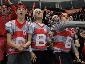 Brennan hockey fans Mitchell McPhee, left, front row, Mitchell Tremblay and Devin Caron, right, react during a tense moment against St. Joseph's Lasers at Father Zakoor Catholic Cup at WFCU Centre Friday December 18, 2015. (NICK BRANCACCIO/Windsor Star)